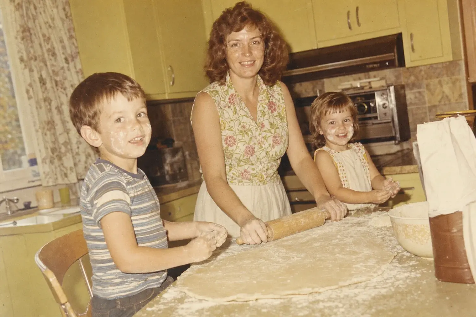 Peggy in her kitchen with her two children, 1968